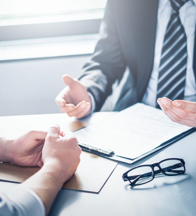 Business people negotiating a contract. Human hands working with documents at desk and signing contract.